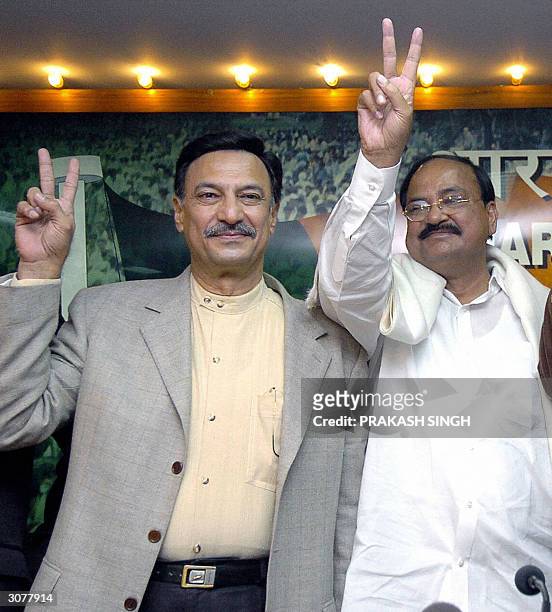 In this file photo taken, 17 February 2004, Indian actor Suresh Oberoi stands alonside Bharatiya Janata Party President Venkaiah Naidu as they show...