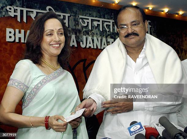In this file photo taken, 19 February 2004, Indian actress Hema Malini receives a party membership card after joining India's ruling Bharatiya Janata...