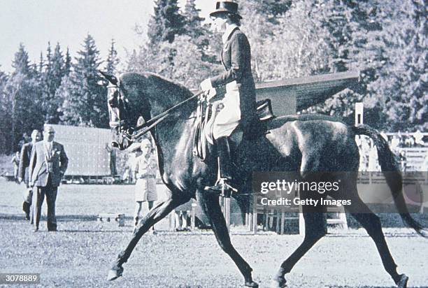 Lis Hartel of Denmark rides atop her horse after becoming the first woman in the sport of equestrian dressage to win a medal during the 1952 Helsinki...