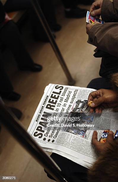 Woman commuting on the NO. 7 train reads an article about the bombing in Madrid March 12, 2004 in New York City. Security at commuter points in the...