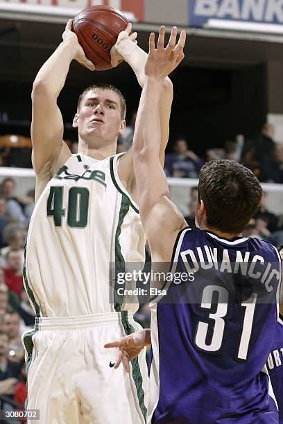 Paul Davis of Michigan State Spartans takes a shot as Davor Duvancic of the Northwestern Wildcats defends during the Big Ten Tournament March 12...