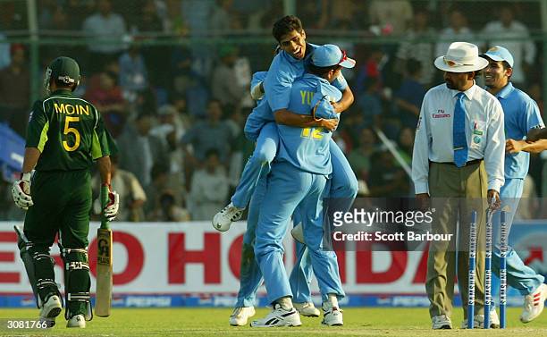 Last man out Moin Khan of Pakistan leaves the field as India celebrate their victory in the first Pakistan v India one day international match played...