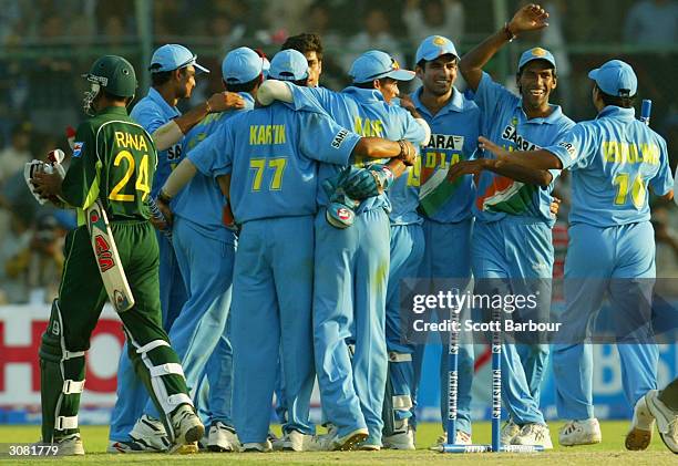 Last man out Moin Khan of Pakistan leaves the field as India celebrate their victory in the first Pakistan v India one day international match played...