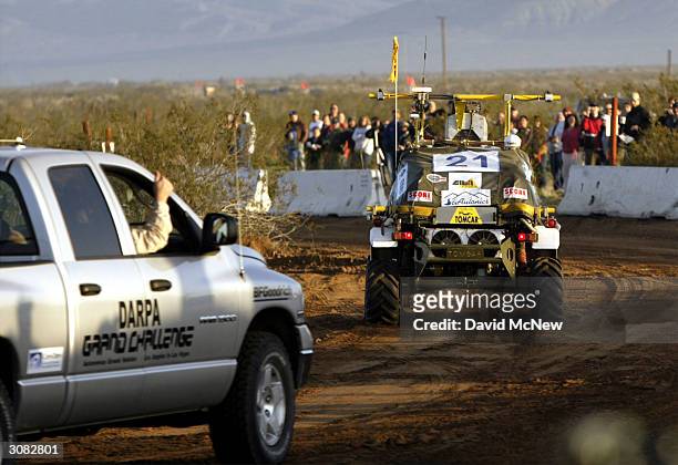 Member of the SciAutononics II team gives a thumbs-up gesture from the chase vehicle as they follow their autonomous, or un-manned, vehicle from the...
