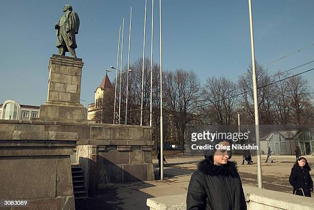 Young woman stands before a statue of Vladimir Lenin March 13, 2004 in the center of Kaliningrad, Russia. Until 1991 the city had lost its...