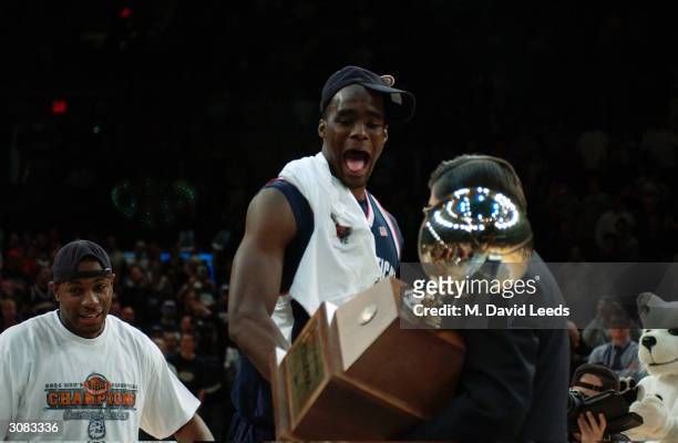 Emeka Okafor of the Connecticut Huskies reacts as he leads his team onto the platform at center court to receive the Big East Championship trophy...