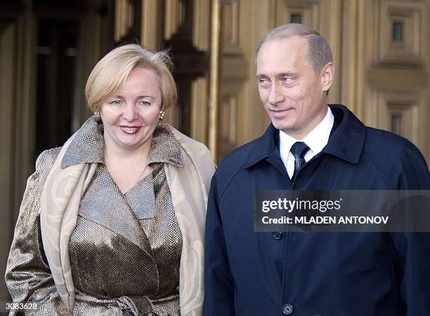 Russian President Vladimir Putin and his wife Ludmilla are seen after casting his vote for the Russian Presidential election, 14 March 2004 at a...