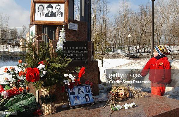 Next to a polling station, the shrine to 116 Russians that died when their apartment block was destroyed by a bomb on Sept. 13 reminds local voters...