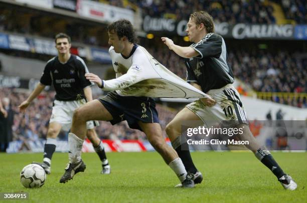 Craig Bellamy of Newcastle United tries to tackle Mauricio Taricco of Tottenham Hotspur during the FA Barclaycard Premiership match between Tottenham...