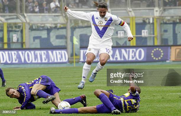 Brescia's Roberto Baggio avoids tackles from two Parma players during the Serie A match between Parma and Brescia on March 14, 2004 in Parma, Italy.