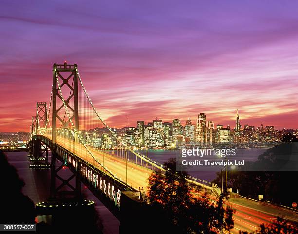 usa, california, san francisco, bay bridge and city skyline at sunset - san francisco stock pictures, royalty-free photos & images