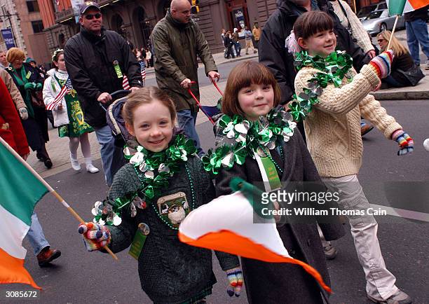 Erin Jordan and Katie Casale waves Irish flags as they march in the 53rd Annual St. Patrick's Day Parade March 14, 2004 in Philadelphia,...