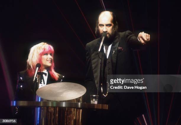 Pink-haired Samantha Fox joins forces with Mick Fleetwood to present the infamous 1989 Brit Awards.