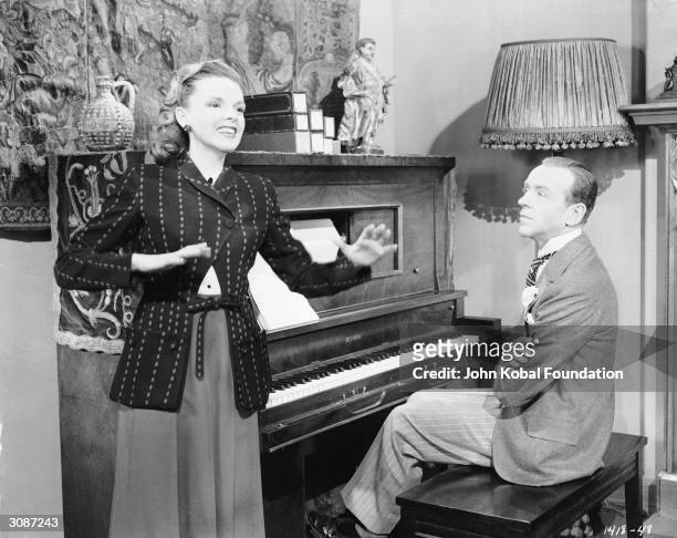 Fred Astaire enjoys a private performance from Judy Garland in a scene from the MGM film 'Easter Parade', directed by Charles Walters, 5th January...