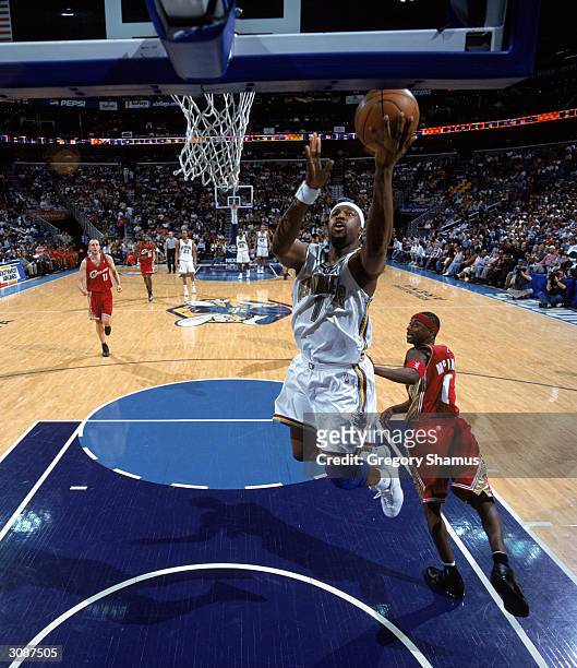 Baron Davis of the New Orleans Hornets goes in for a layup during the game against the Cleveland Cavaliers at New Orleans Arena on March 5, 2004 in...
