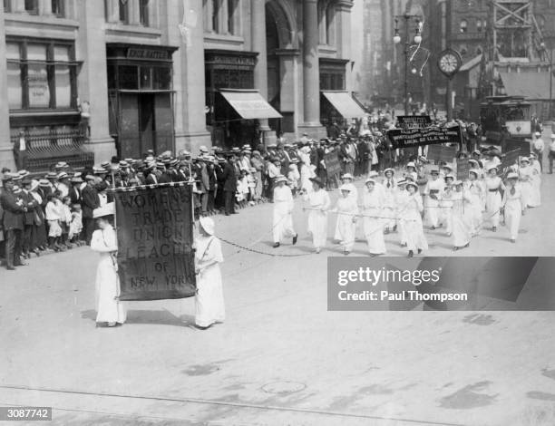 Suffragettes carrying the banner of the Women's Trade Union League of New York on a Labour Day Parade through the city.