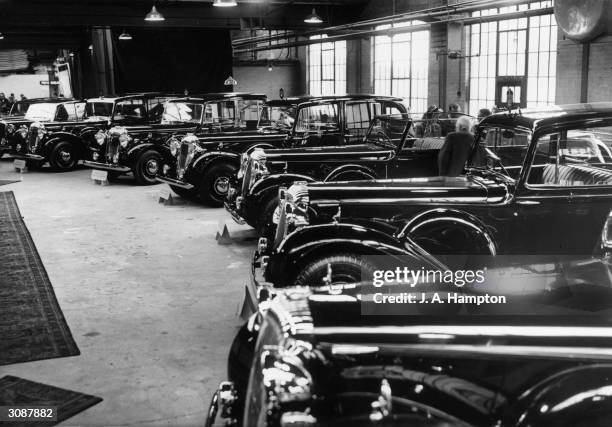 Row of fourteen Daimlers ordered specifically by the South African government for the upcoming Royal Tour of King George VI and Queen Elizabeth. The...