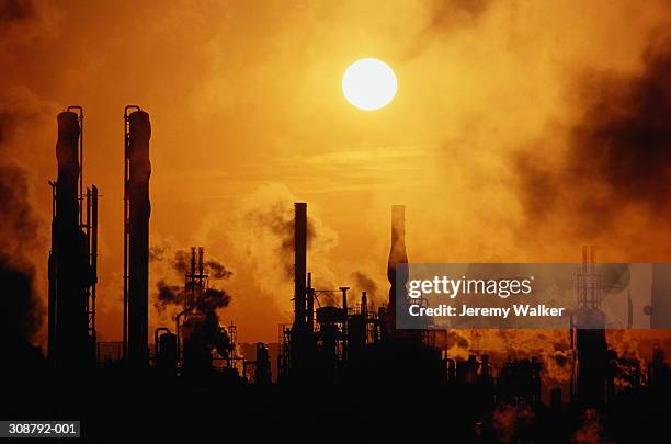 chemical plant silhouetted at sunset - avonmouth stock pictures, royalty-free photos & images