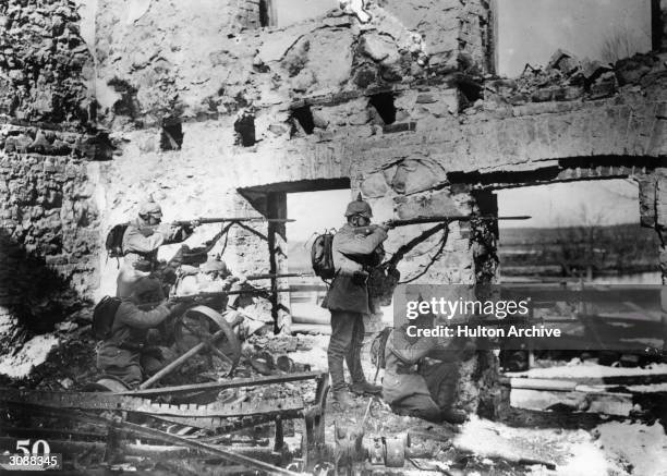 German soldiers sniping from a ruined house during World War I, using 7.92 mm Gewehr 98 rifles.