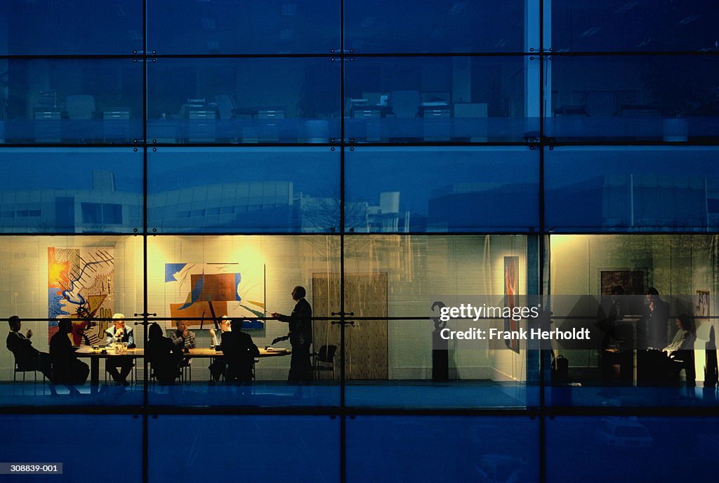 Executives in conference room, view through window