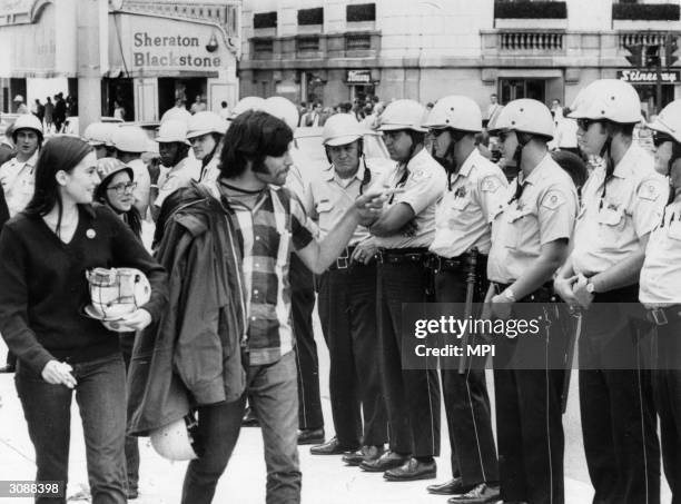 Group of hippies taunting policemen during the trial of the Chicago Seven, a group of radicals arrested during the protests against the Vietnam war...