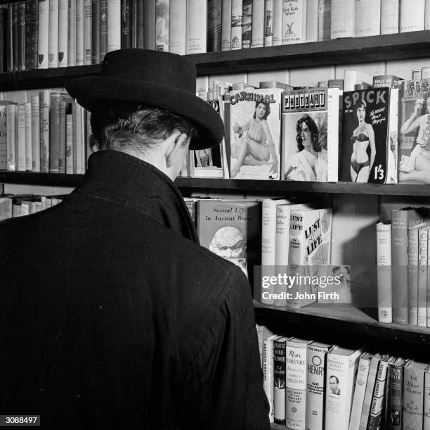 Peruser contemplates the pornography section at a Soho sex shop in London.