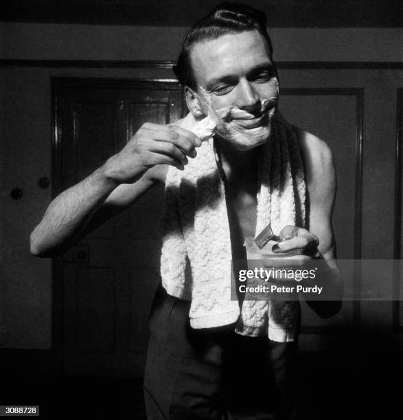 Man lathers up with shaving soap.