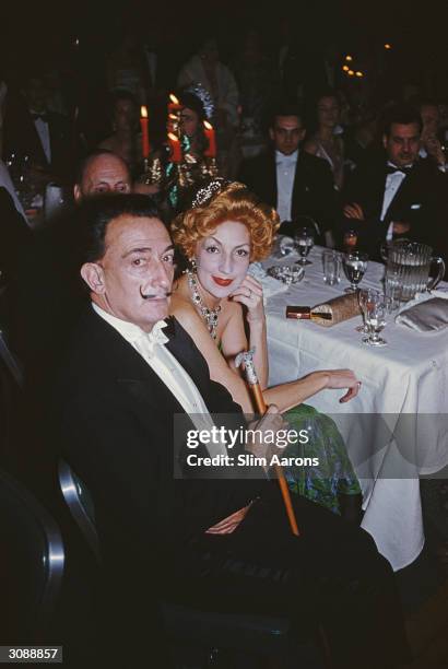 Surrealist painter Salvador Dali with a red-haired woman at a ball in New York. A Wonderful Time - Slim Aarons