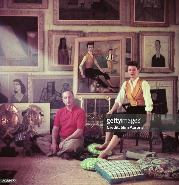 Romanian director Jean Negulesco and his model wife Dusty sitting before a portrait of Dusty by Noyer. Negulesco directed the film, 'Three Coins in...