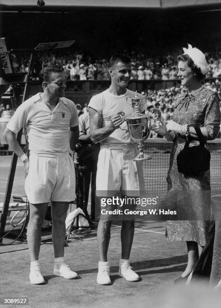 The Duchess of Kent talks to the finalists in the Men's Singles Championship at Wimbledon. Ted Schroeder of the USA, holding the trophy, beat...