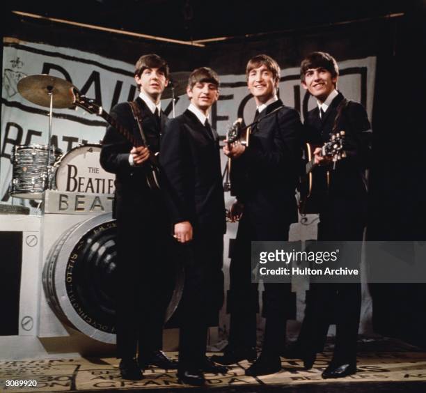 Liverpudlian beat combo The Beatles, from left to right Paul McCartney, Ringo Starr, John Lennon , and George Harrison , performing in front of a...