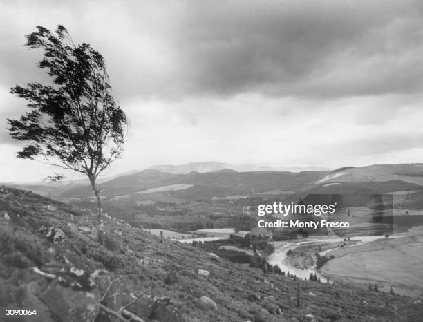 The River Dee flowing through the valley at Ballater, in the Scottish Highlands.