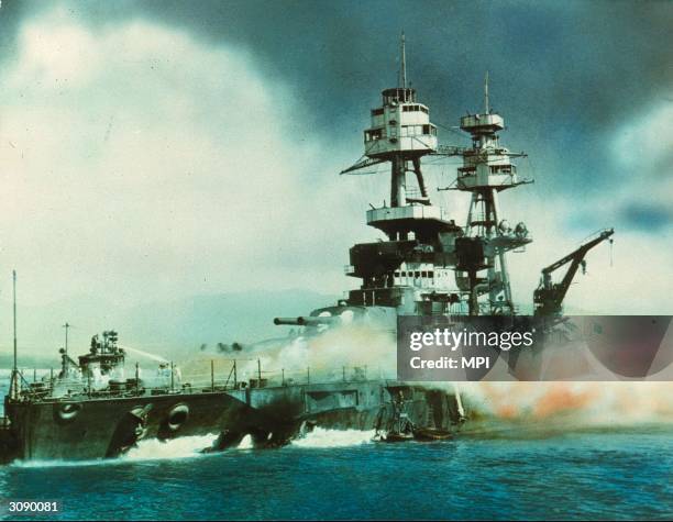 Nevada on fire in Pearl Harbour , Oahu Island after the attack by the Japanese which brought America into WW II.