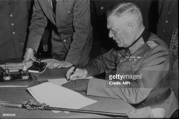 Field Marshal Wilhelm Keitel , Hitler's chief military adviser in WW II, signing the unconditional surrender to the Allies and Russians in Berlin. A...