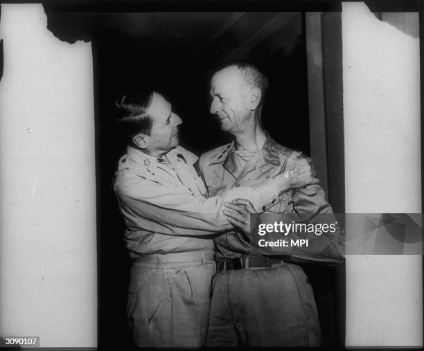 General MacArthur embraces Lt General Wainwright who was taken prisoner by the Japanese after the US retreat in the Bataan peninsula and released in...