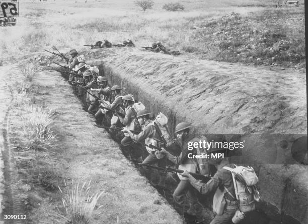 1st African American Division in training in Arizona take aim from a slit trench.