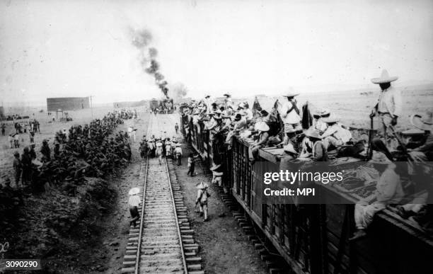 The Carranzistas pass through the camp of the US 6th Infantry near San Antonio, Mexico on their way to fight Pancho Villa and his revolutionaries.