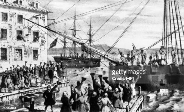 Group of Bostonians dressed as Native Americans dump crates of imported British tea into Boston Harbour as a protest against the British Tea Act....