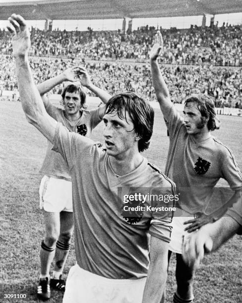 From left to right, Dutch footballers Johnny Rep, Johan Cruyff, and Johan Neeskens waving to the crowds before the World Cup Final against West...