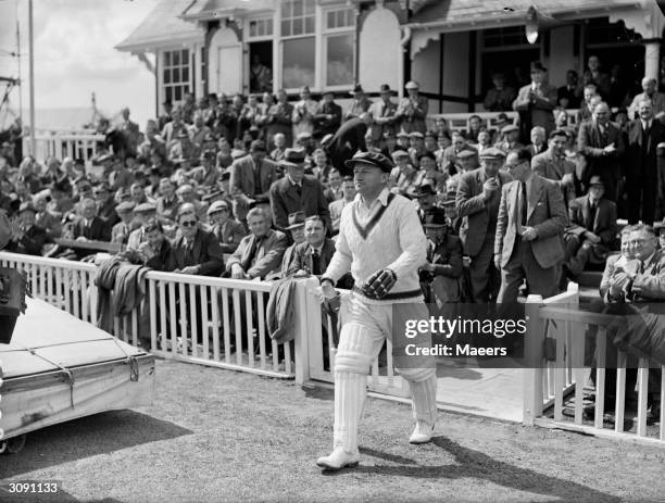 Australian cricketer Don Bradman walks out to bat against Worcestershire. Sir Donald Bradman was the first cricketer to be knighted in 1949 for his...