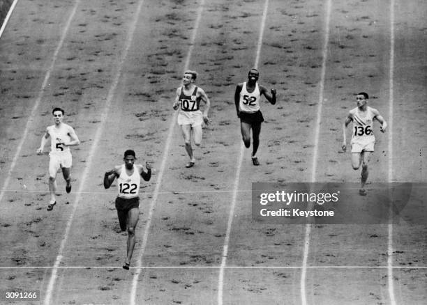 Arthur Wint of Jamaica wins the semi-final of the 400 metres event at the 1948 London Olympics, with Morris Curotta of Australia in second and Mal...