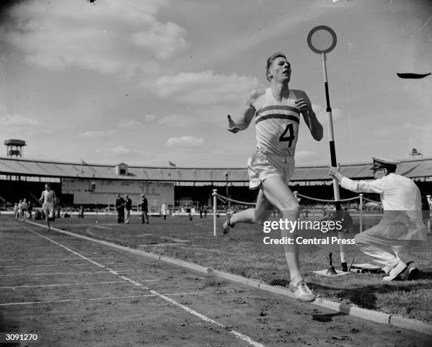 British middle-distance runner Roger Bannister comfortably winning the one mile race in record time during the AAA Championships at White City...