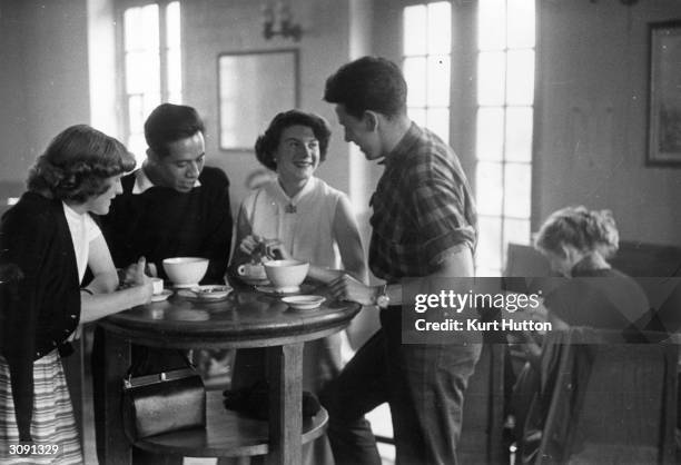 British students, Janet Snell and Vera Kaden from St Andrew's University studying French at the Sorbonne, Paris chat with friends over a cup of...