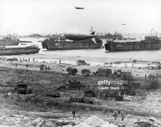 Allied soldiers, tanks and ships take part in the D-Day landings at Arromanches beach in Normandy, Northern France.