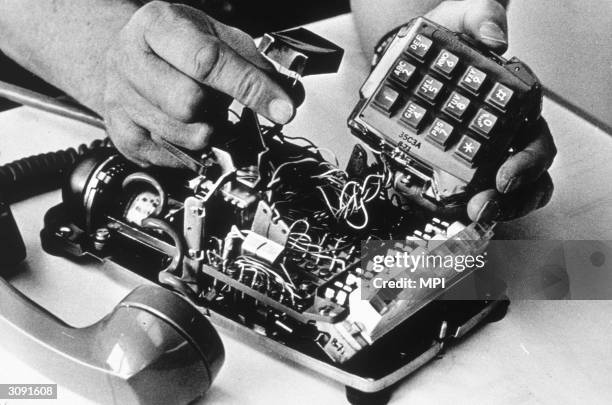 Man placing a tap in a phone.