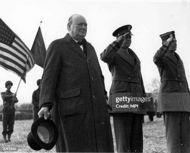 British Prime Minister Winston Churchill , American general Dwight Eisenhower and Brigadier General Maxwell D. Taylor reviewing the 101st Airborne...