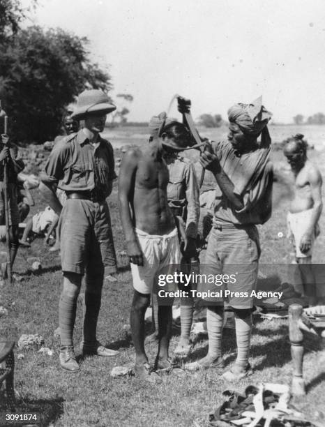 An Akali Sikh is arrested at Amritsar in the Punjab.