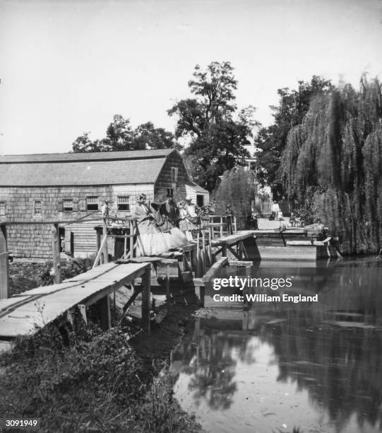 Party of Americans take in the view from a bridge in Sleepy Hollow, Tarrytown, New York.