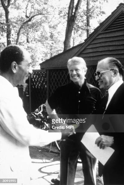 American President Jimmy Carter with the Egyptian President Anwar Sadat and Israeli Prime Minister Menachem Begin at Camp David during peace talks....