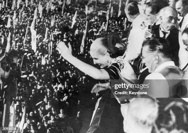 Eva Peron , the second wife of Argentinian president Juan Peron greeting the crowds from the balcony of Government House, Buenos Aires on the fifth...